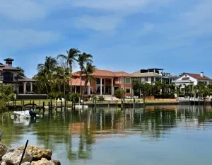 Scenic view of luxury homes along the Sarasota waterfront, surrounded by palm trees and calm waters. in Sarasota Scavenger Hunt, FL