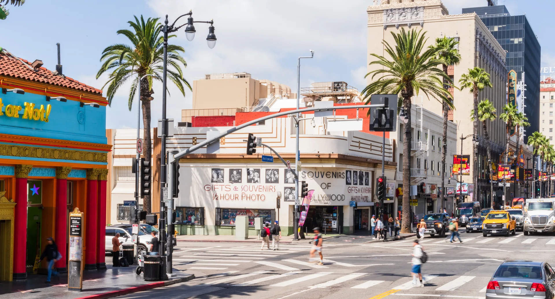Busy street scene on Hollywood Boulevard with souvenir shops under palm trees, Los Angeles. in Hollywood Scavenger Hunt