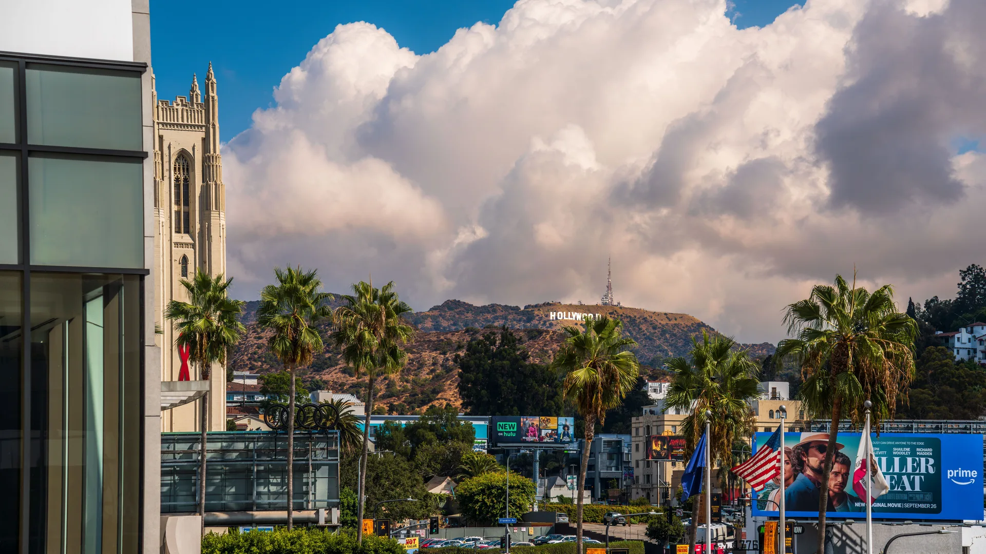 View of the Hollywood Sign with palm trees and city scene in West Hollywood, California. in Hollywood Scavenger Hunt