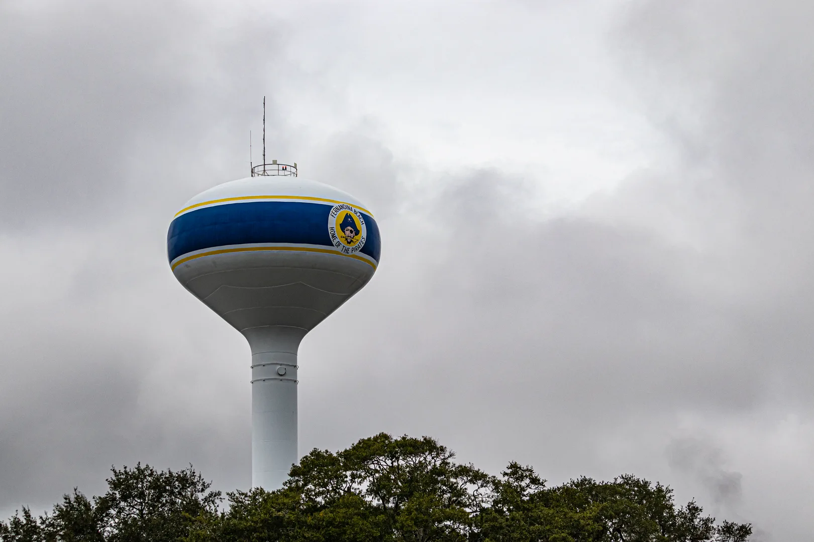 A tall water tower in Fernandina Beach, Florida stands against a dramatic cloudy sky. in Fernandina Beach Scavenger Hunt