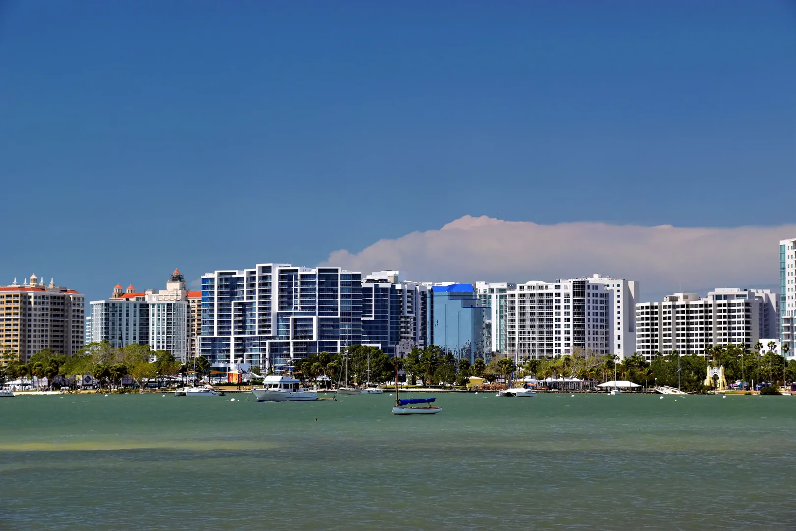 Panoramic view of Sarasota, Florida skyline against a blue sky, featuring modern architecture and waterfront. in Sarasota Scavenger Hunt