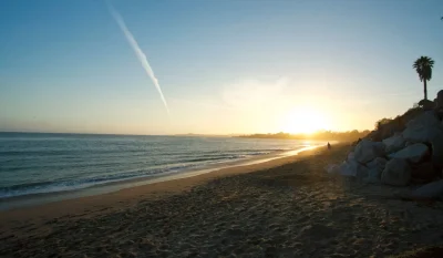 Peaceful beach at sunset in Santa Cruz, California, with tranquil waves and golden light. in Santa Cruz Scavenger Hunt