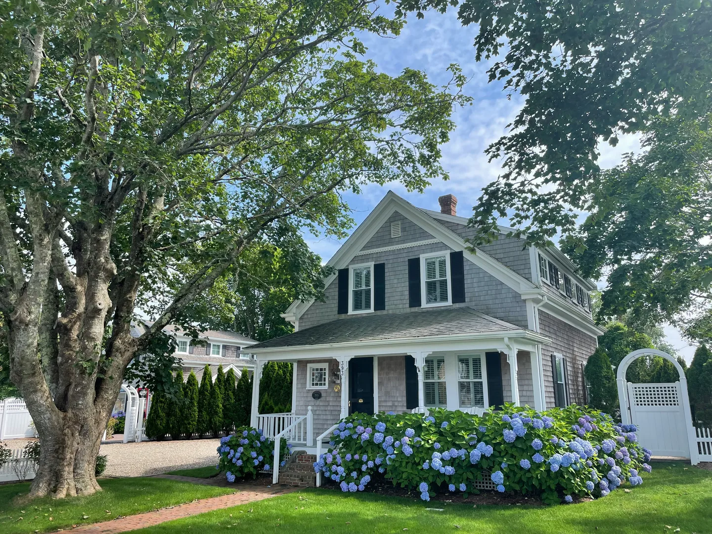 white and gray wooden house near green trees under white clouds during daytime in Chatham Massachusetts Scavenger Hunt