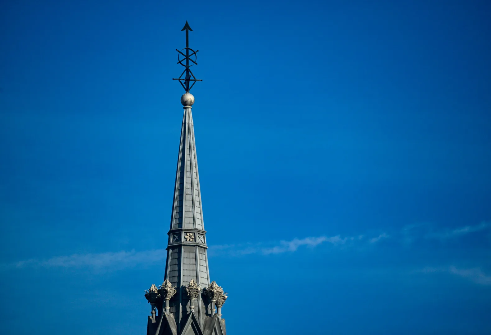 A detailed view of a church steeple reaching towards a clear blue sky. Captured in Covington, KY. in Covington Kentucky Scavenger Hunt